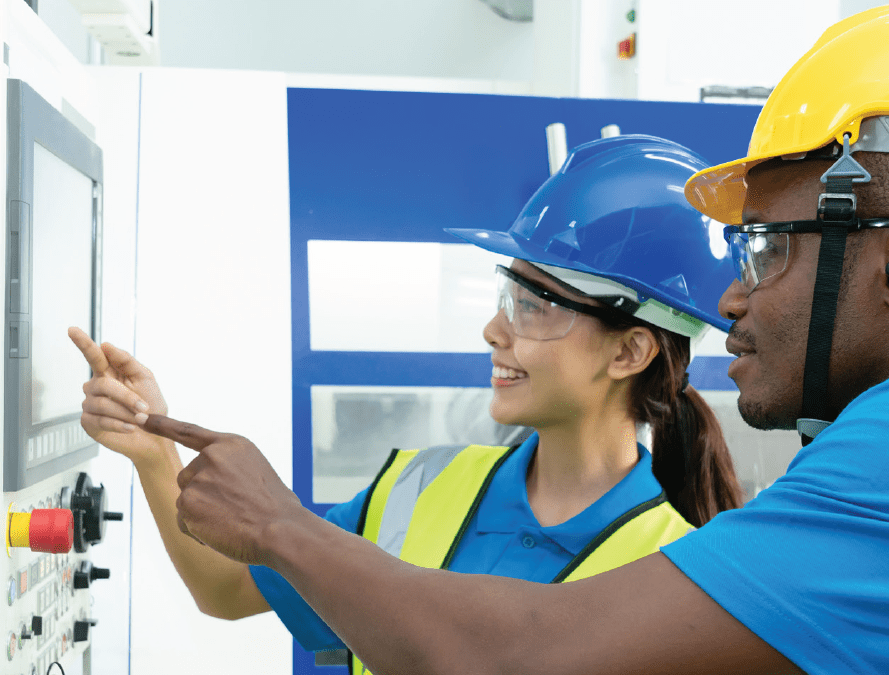 Photo introduces a workshop flyer for the public to explore and learn about clean energy jobs and how the programs can assist with training and job opportunities. The photo is a profile view of a man and a woman pointing to a screen and wearing hardhats and yellow vests.