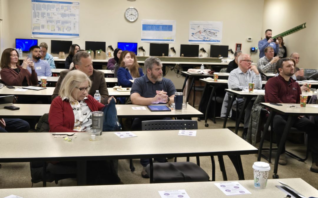Photo of our Board members in a meeting room sitting at tables.